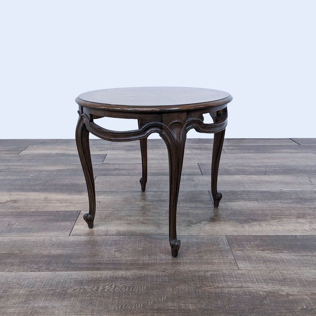 a round table with a curved top and a curved leg.