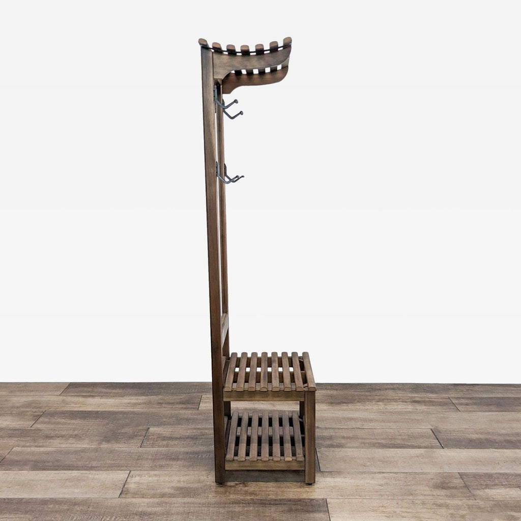 Side view of a wooden hall tree showing hooks and slatted shelves for storage.