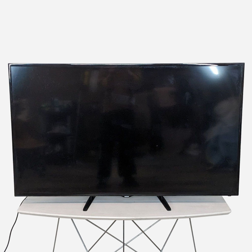 a large flat screen tv on a stand.