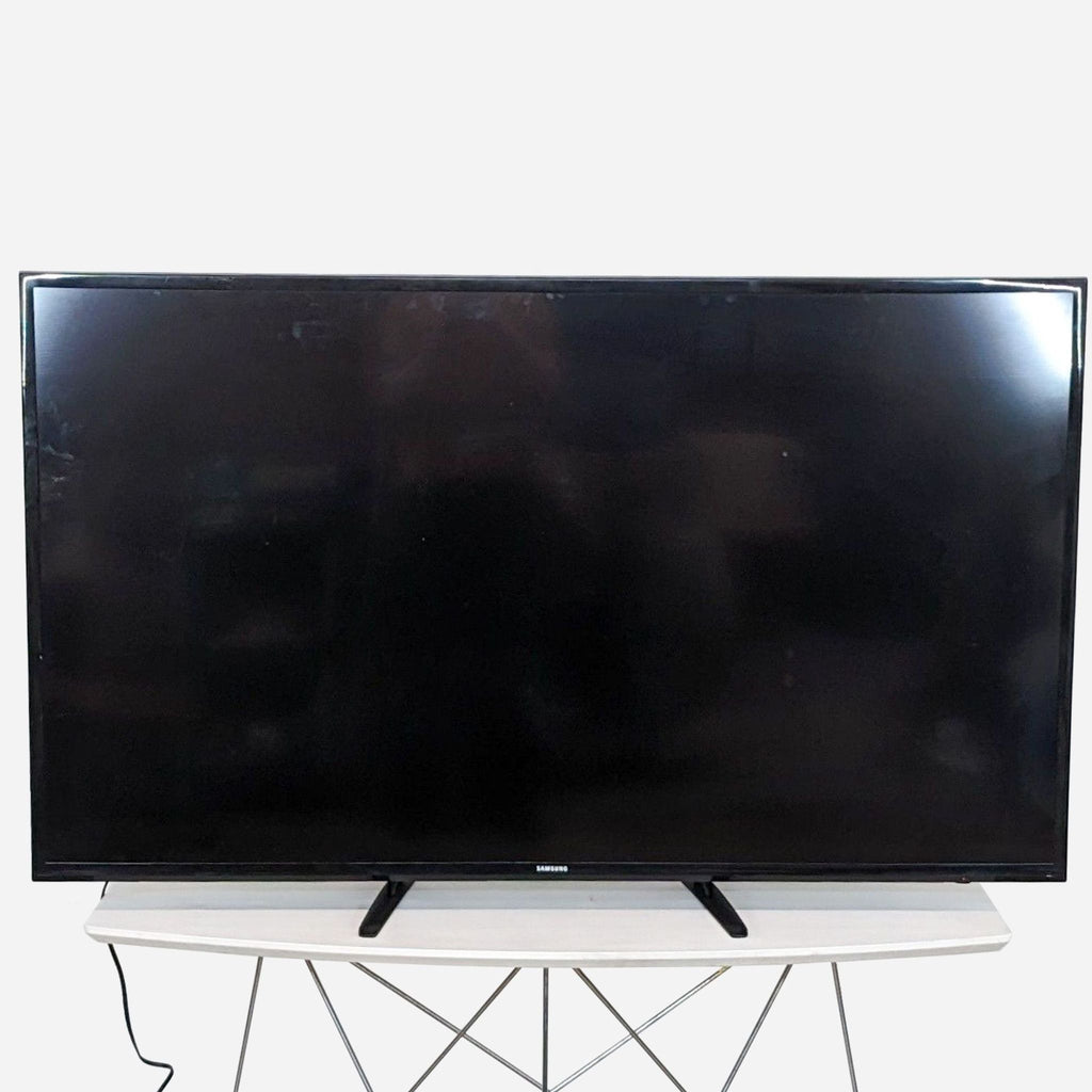 a large flat screen tv on a stand.