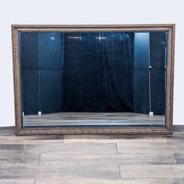 a large antique mirror with a wood frame and a black frame.