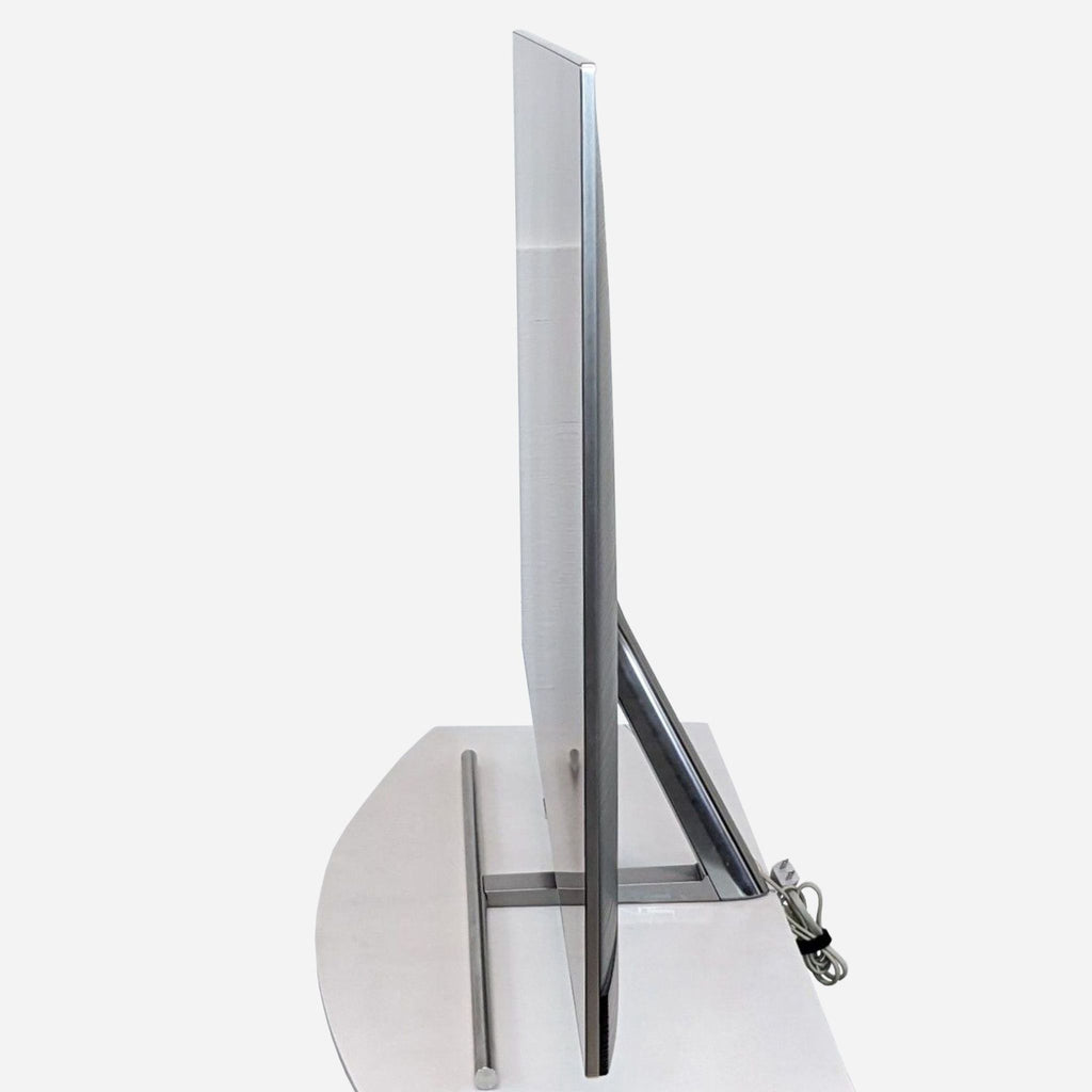 Side view of Samsung's slim 55-inch QLED TV on a stylish stand.