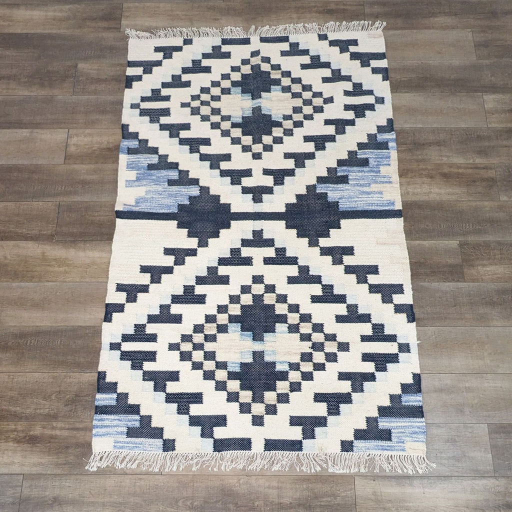 Checkerboard Diamond Dhurrie rug by West Elm with textured wool and muted blue tones.