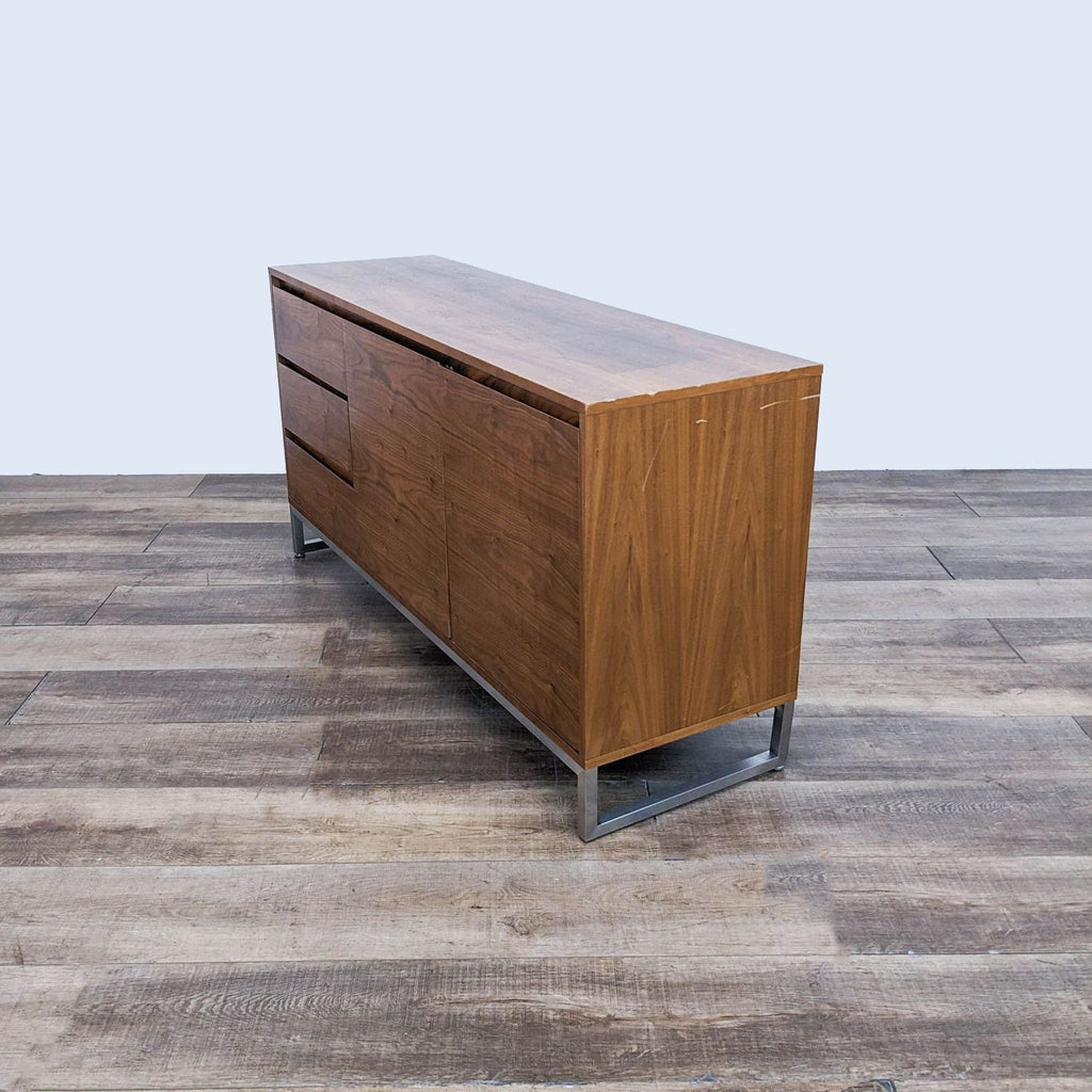 Side angle of the Gus dresser, highlighting its sleek walnut design and steel base.