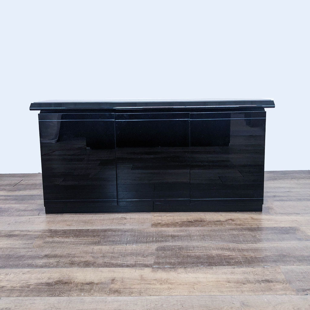 a black lacquered wood and glass sideboard.