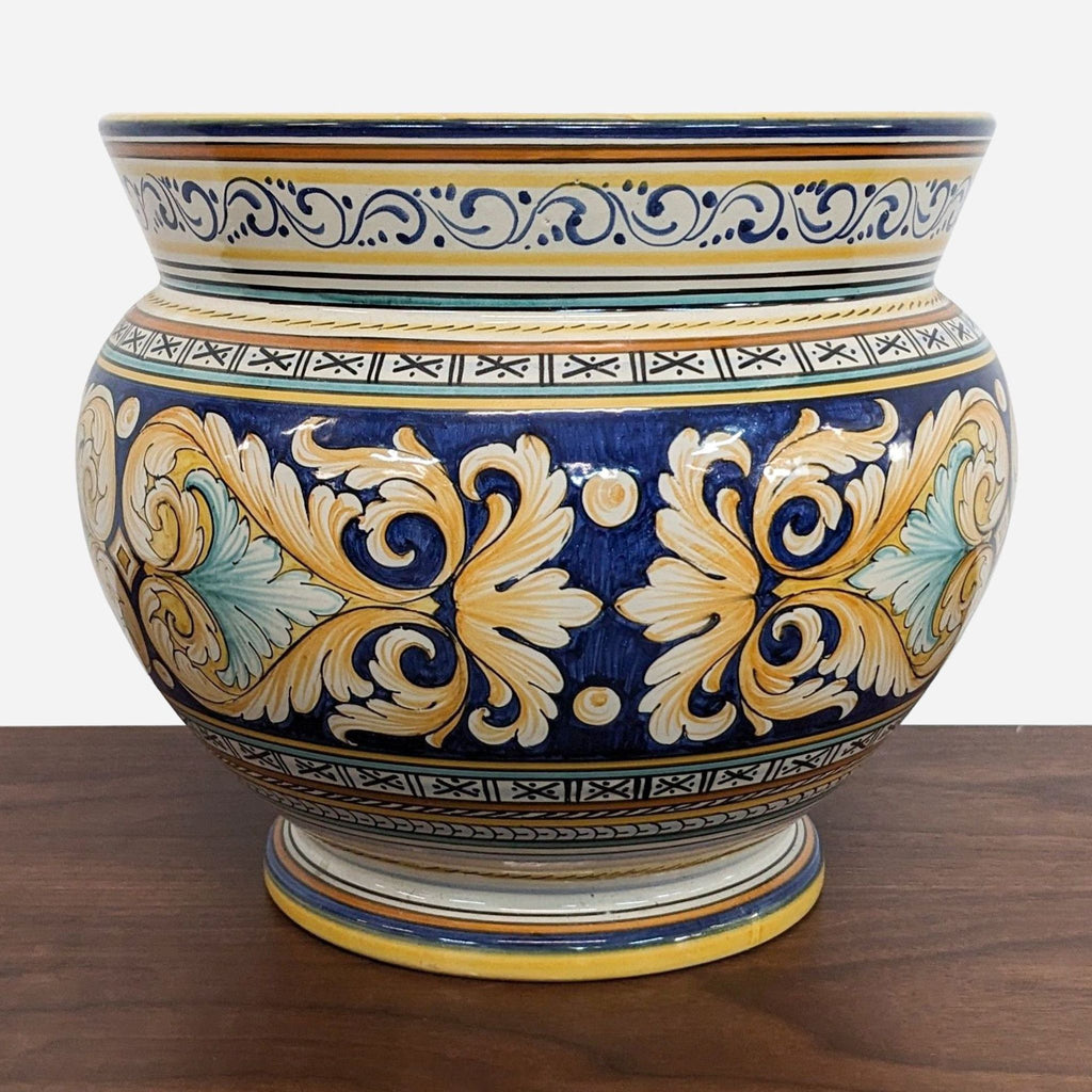 a large blue and yellow vase with floral design