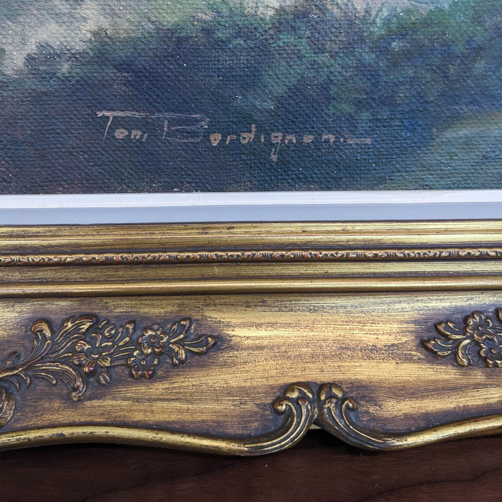 Close-up of Toni Bordignon's signature on ornate gold frame.