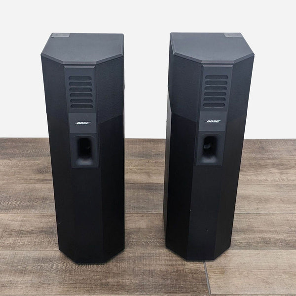 a pair of speakers on a wooden floor