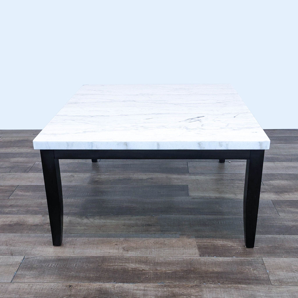 a marble coffee table with a black marble top.