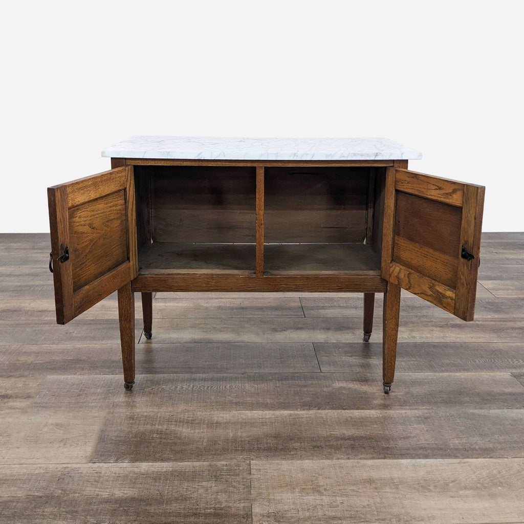 a walnut and oak sideboard with a marble top.