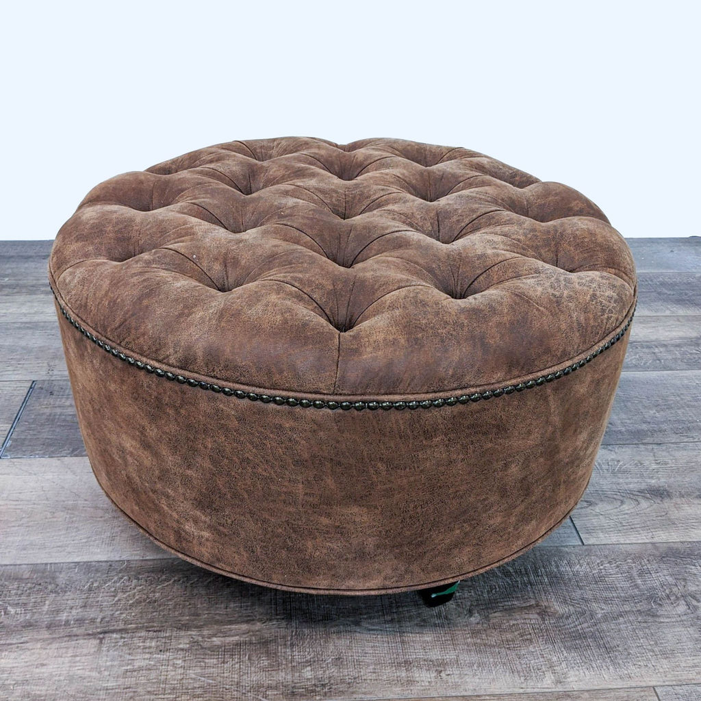 Reperch tufted brown leather ottoman with nailhead accents and dark finish feet.