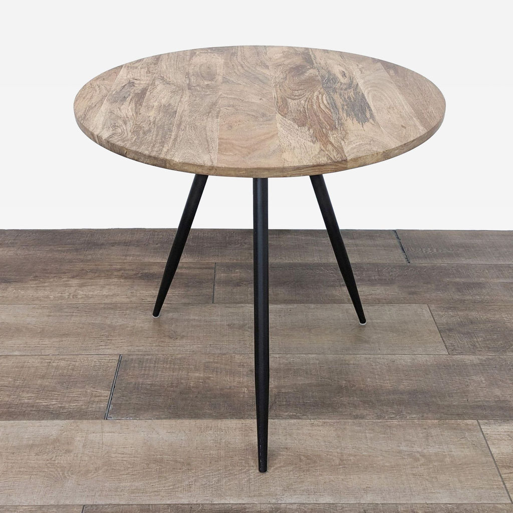 West Elm dining table with wooden top and black metal legs.