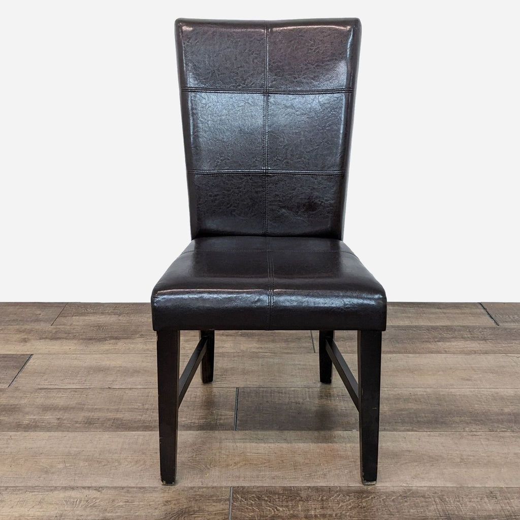 a pair of black leather dining chairs