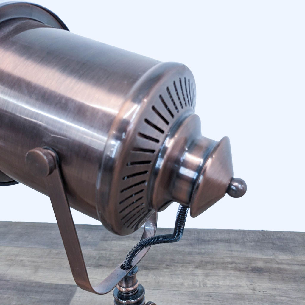 Close-up of a bronze spotlight lamp showcasing its detailed vented casing.