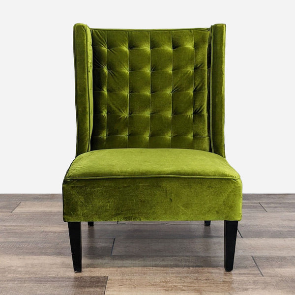 a green velvet chair with a buttoned up back.