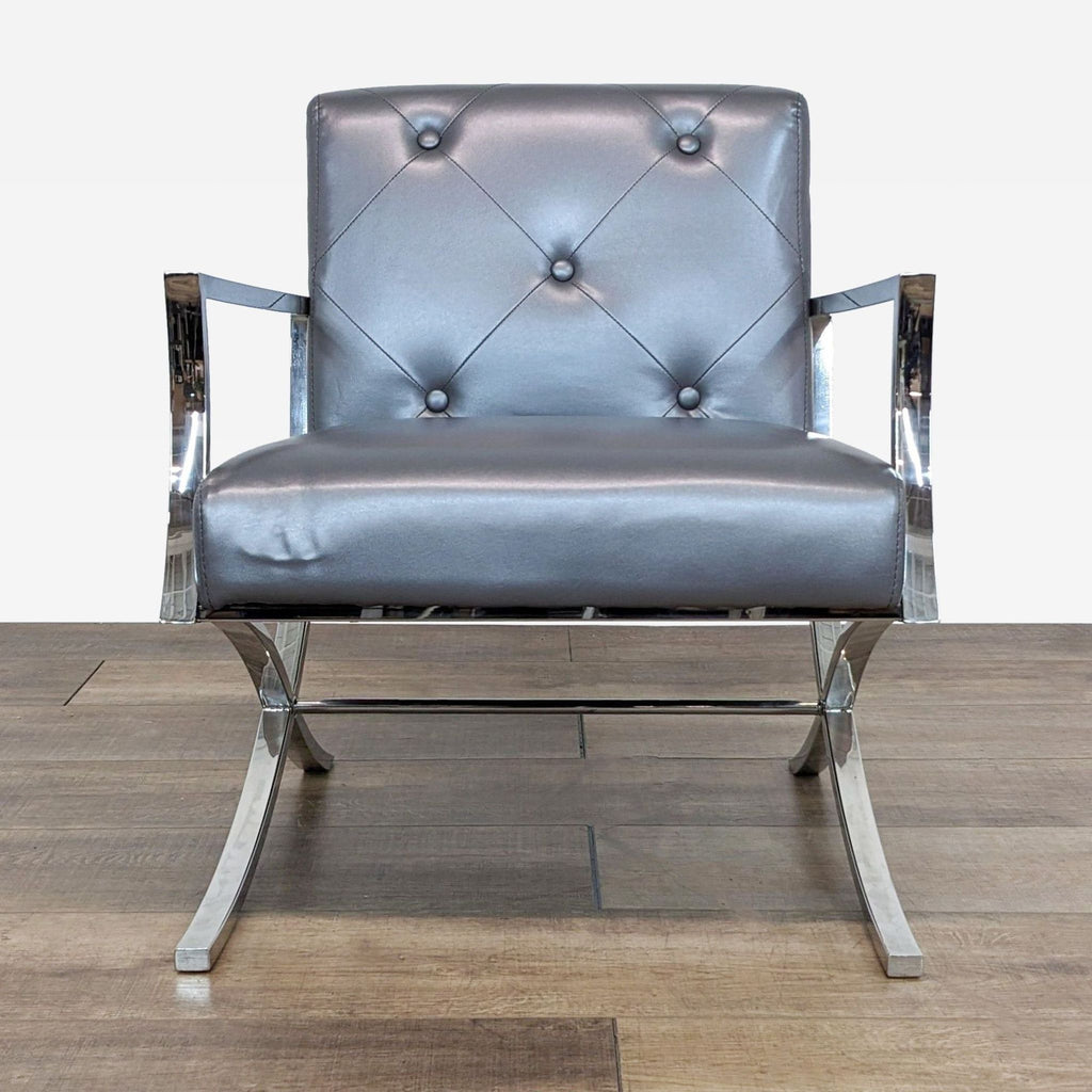 a pair of chrome and leather lounge chairs by [ unused0 ].