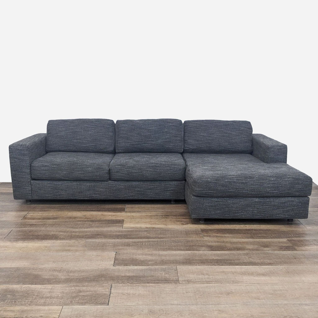 Gray sectional sofa with chaise from West Elm, showcasing modern design and comfort.  