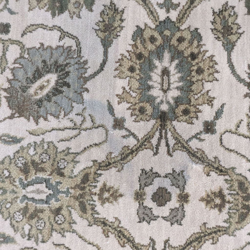 a close up of a blue and grey floral design on a beige background.