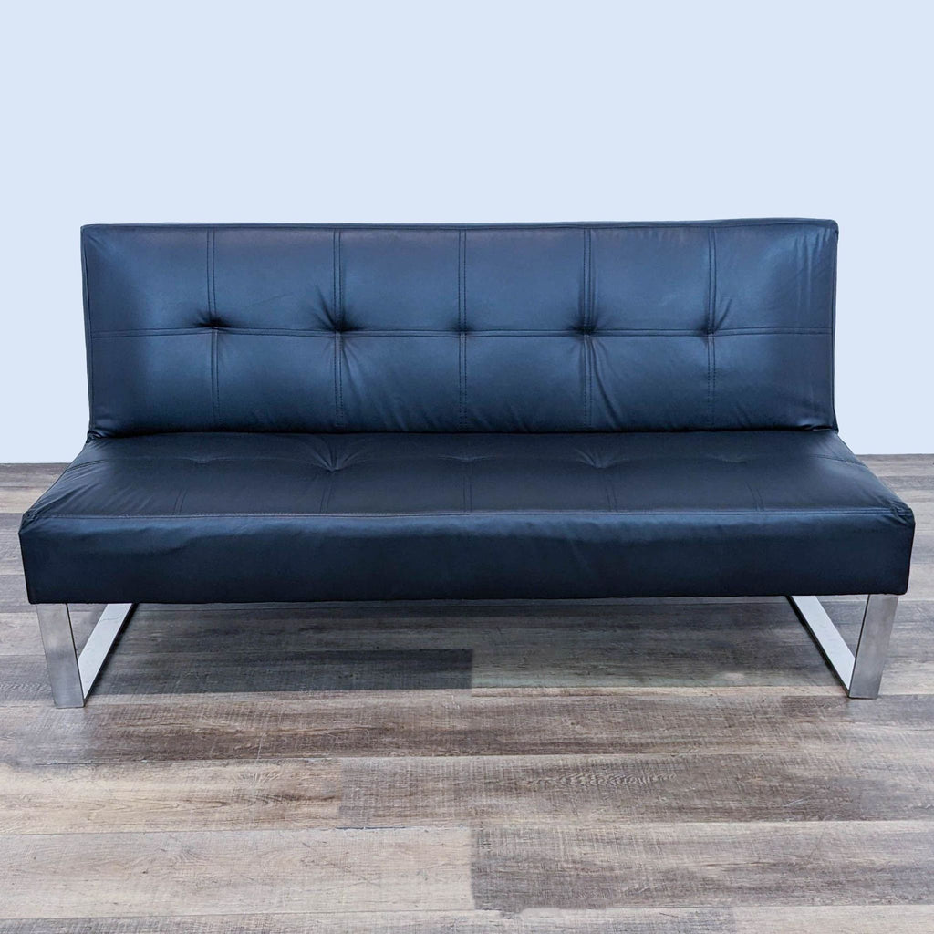 a black leather sofa by [ unused0 ] for [ unused0 ].