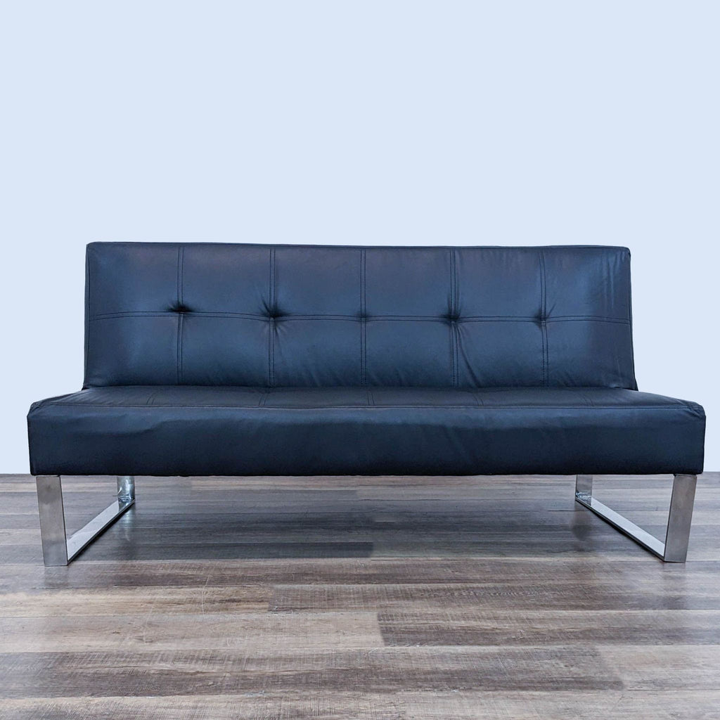 a blue leather sofa by [ unused0 ] for [ unused0 ].