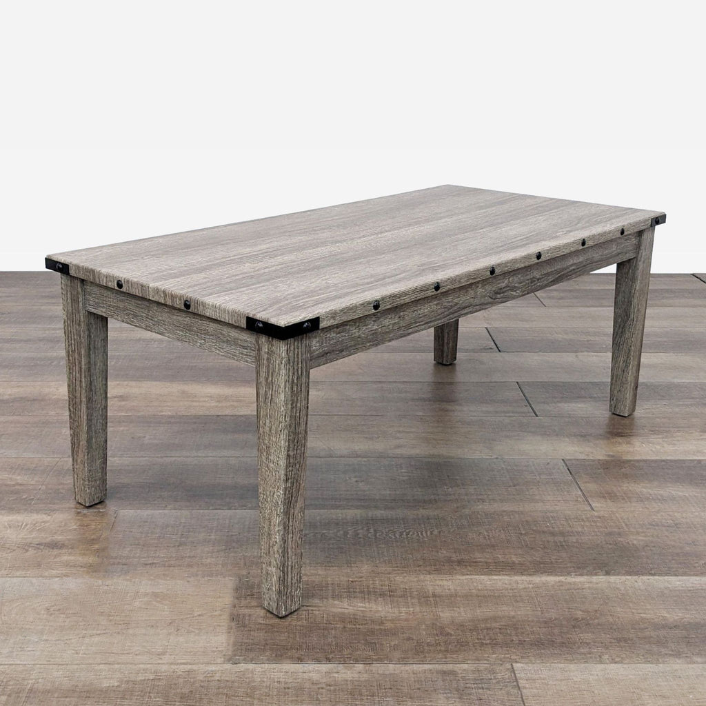 a coffee table made of solid wood with a metal top.