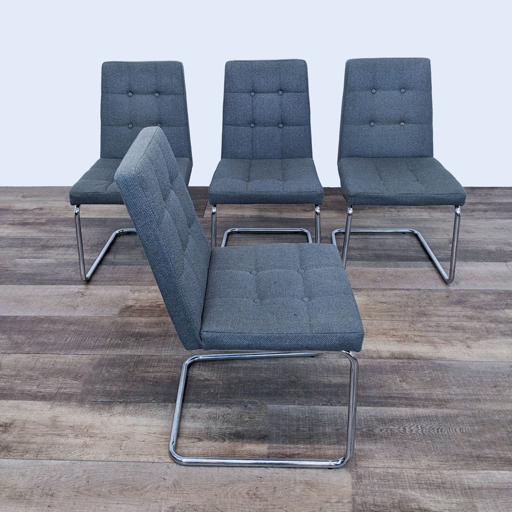 a set of four chrome and steel dining chairs