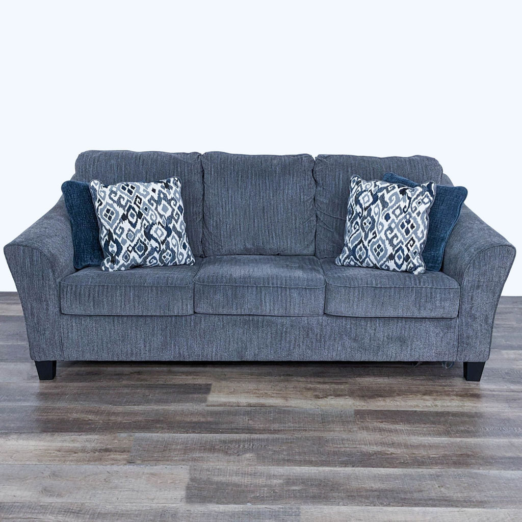 sofa in a grey fabric with blue pillows