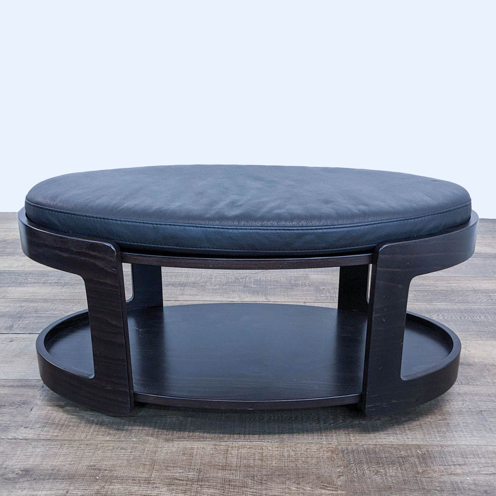 a black leather ottoman with a black leather seat.