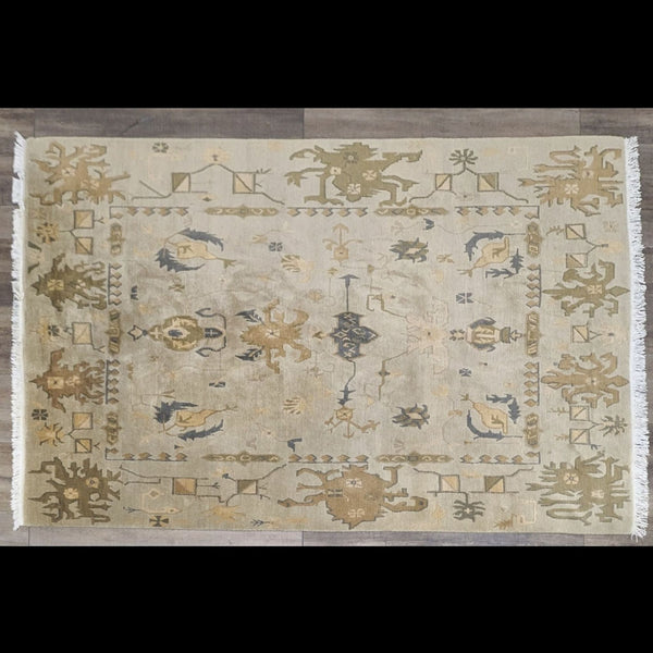 a handmade rug with a large oriental design.