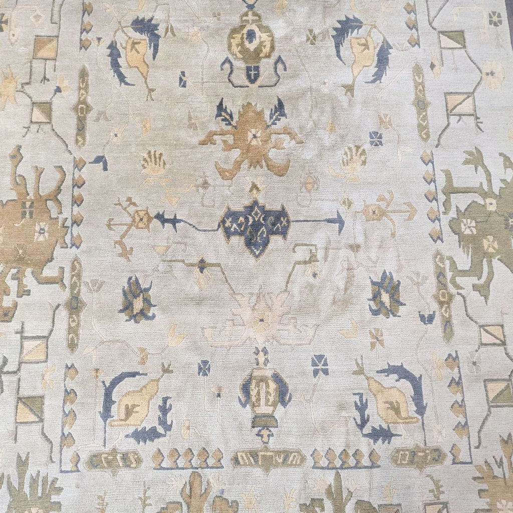 a hand - knotted rug with a blue and white design.