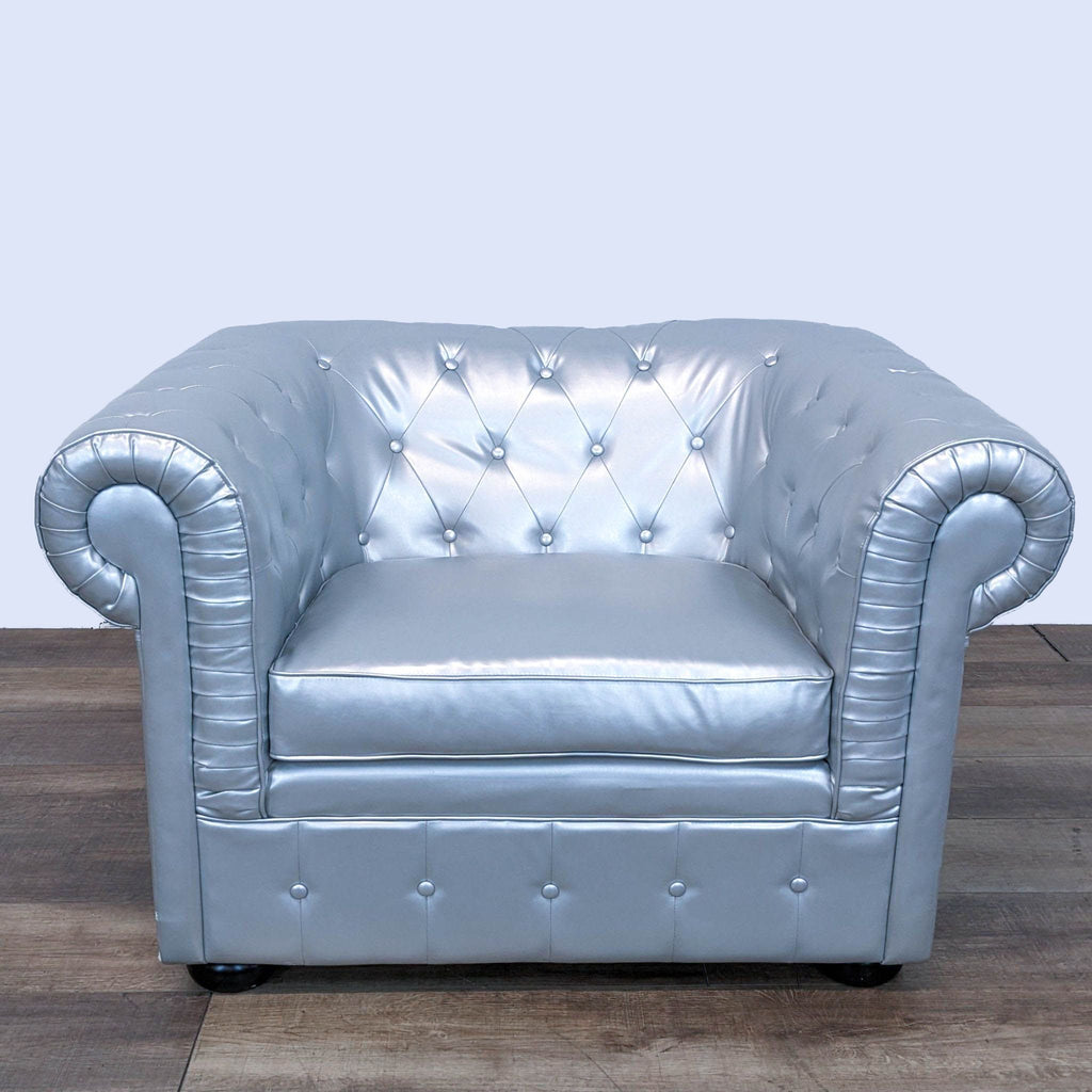 a silver leather chair with a silver studded seat and back.