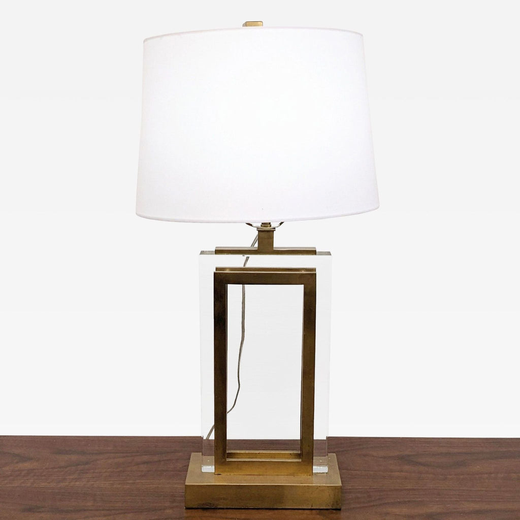 a mid century modern brass table lamp with a white shade.