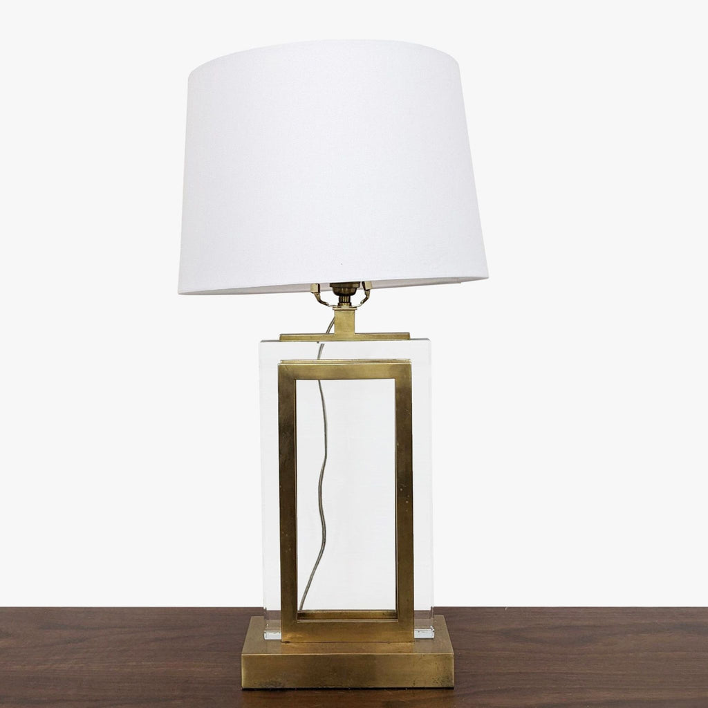 a brass table lamp with a white shade.