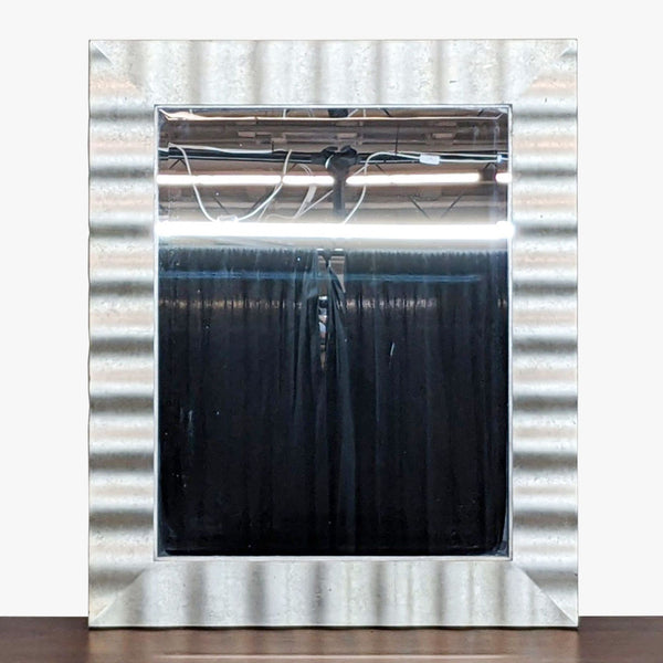 a large industrial mirror with a metal frame.