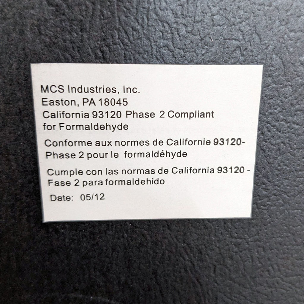 a label on a metal wall.