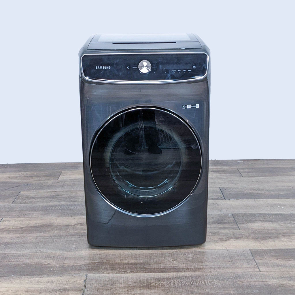 a washing machine on a wooden floor.