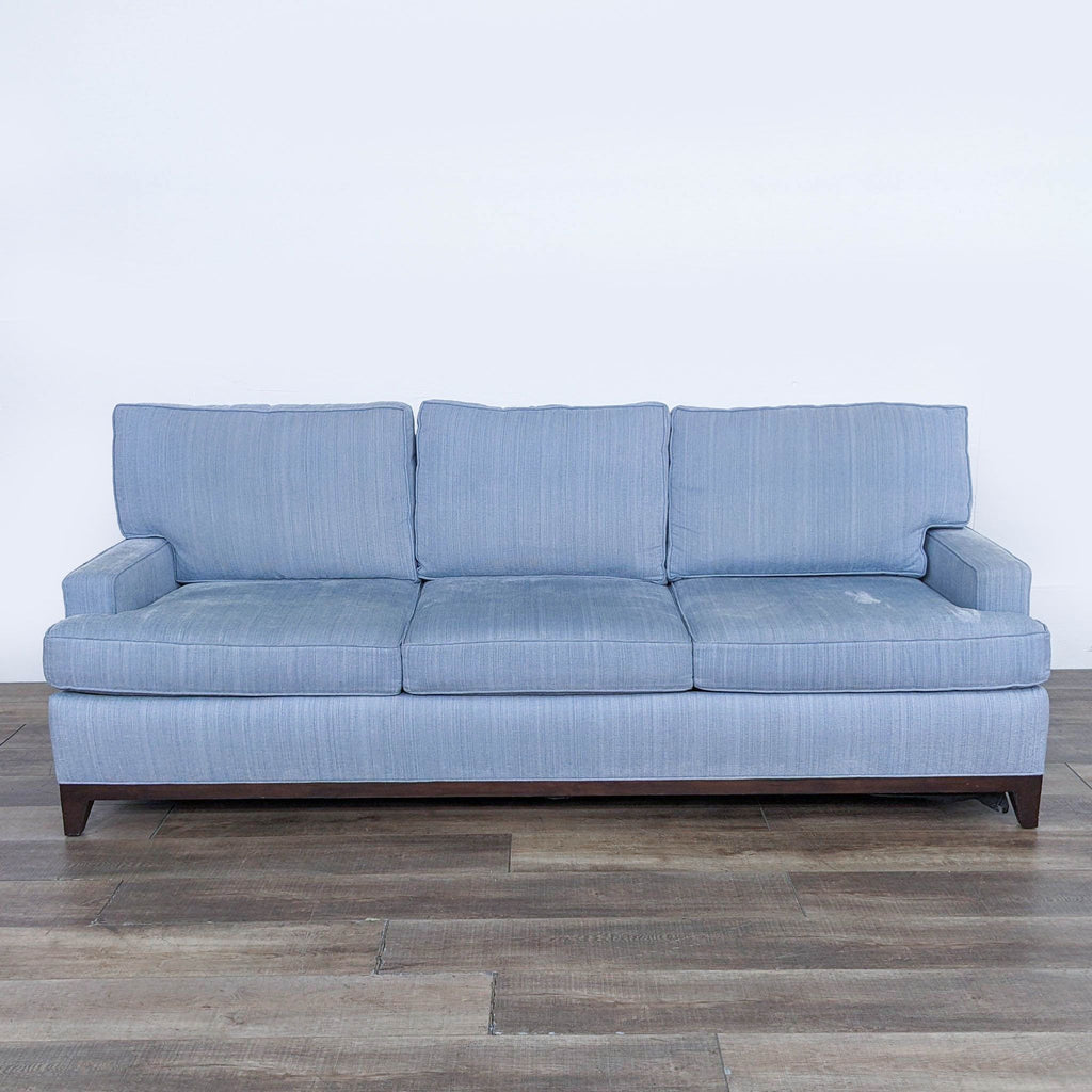 Cypress 3-seat sofa with light blue upholstery and wooden legs, front view.