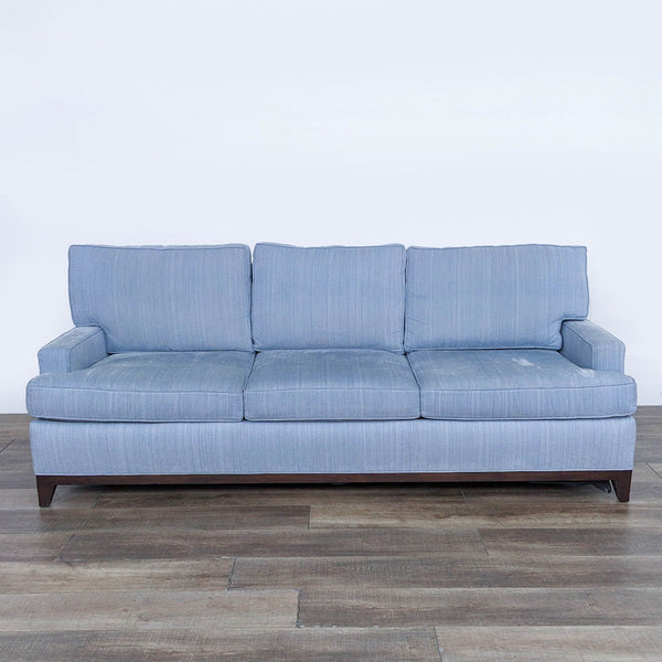 Cypress 3-seat sofa with light blue upholstery and wooden legs, front view.