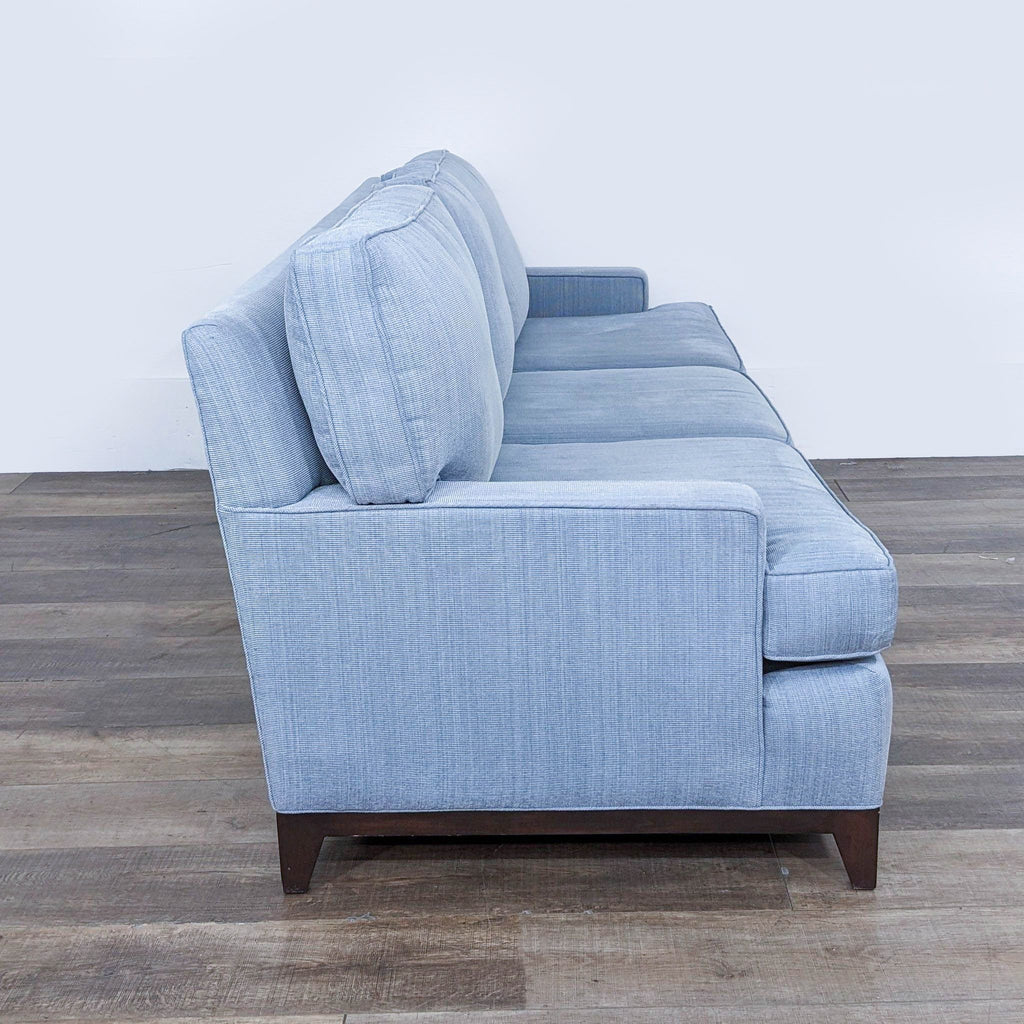 Side view of the Cypress 3-seat sofa, featuring light blue fabric and wood feet.
