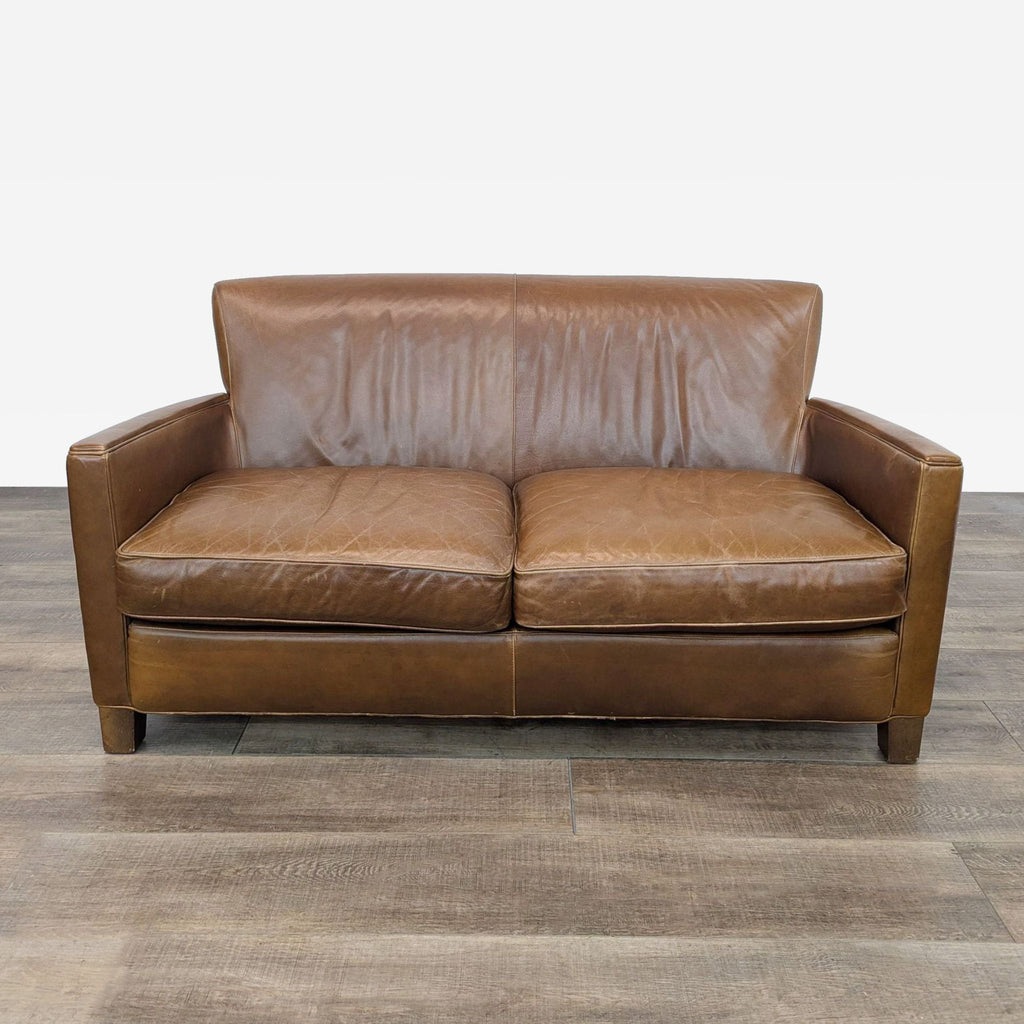 a leather sofa with a leather back and a backrest.