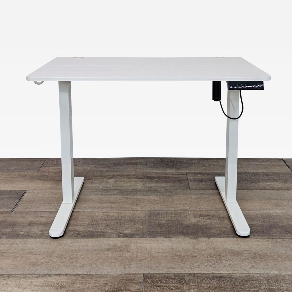 white desk with a white metal frame and a black cord