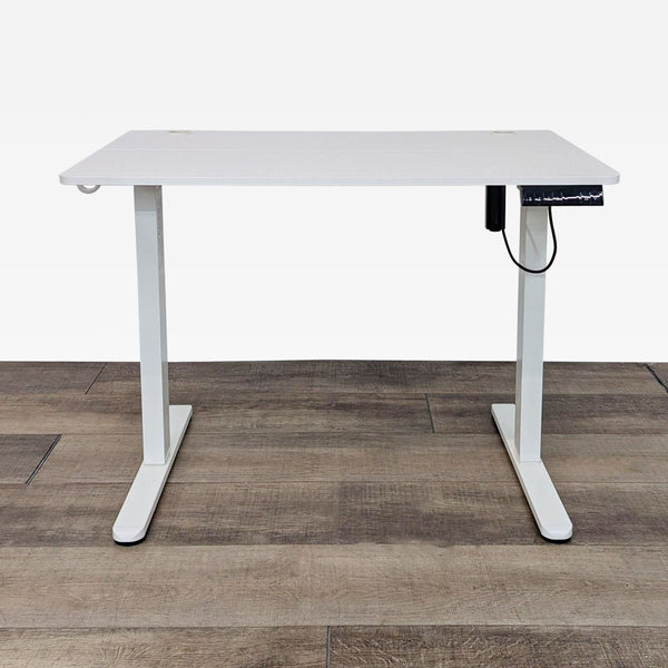 white desk with a white metal frame and a black cord