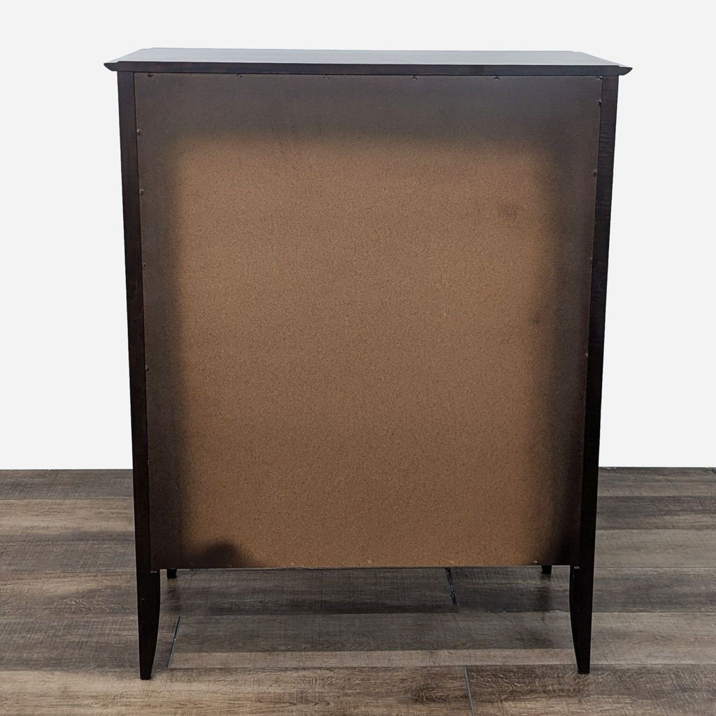 a vintage french dark brown and black cabinet with a brown fabric top.