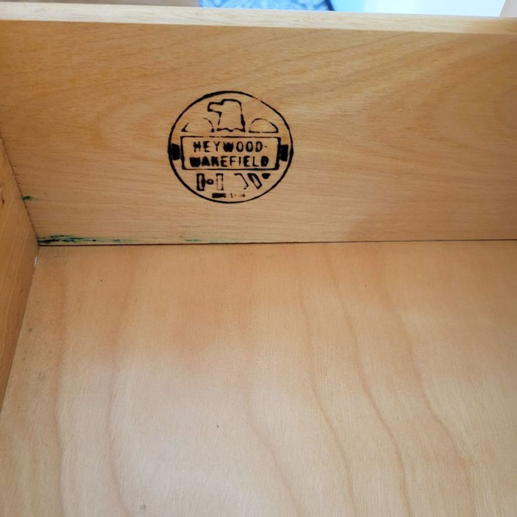 Close-up of the Heywood-Wakefield stamp inside the sideboard drawer.