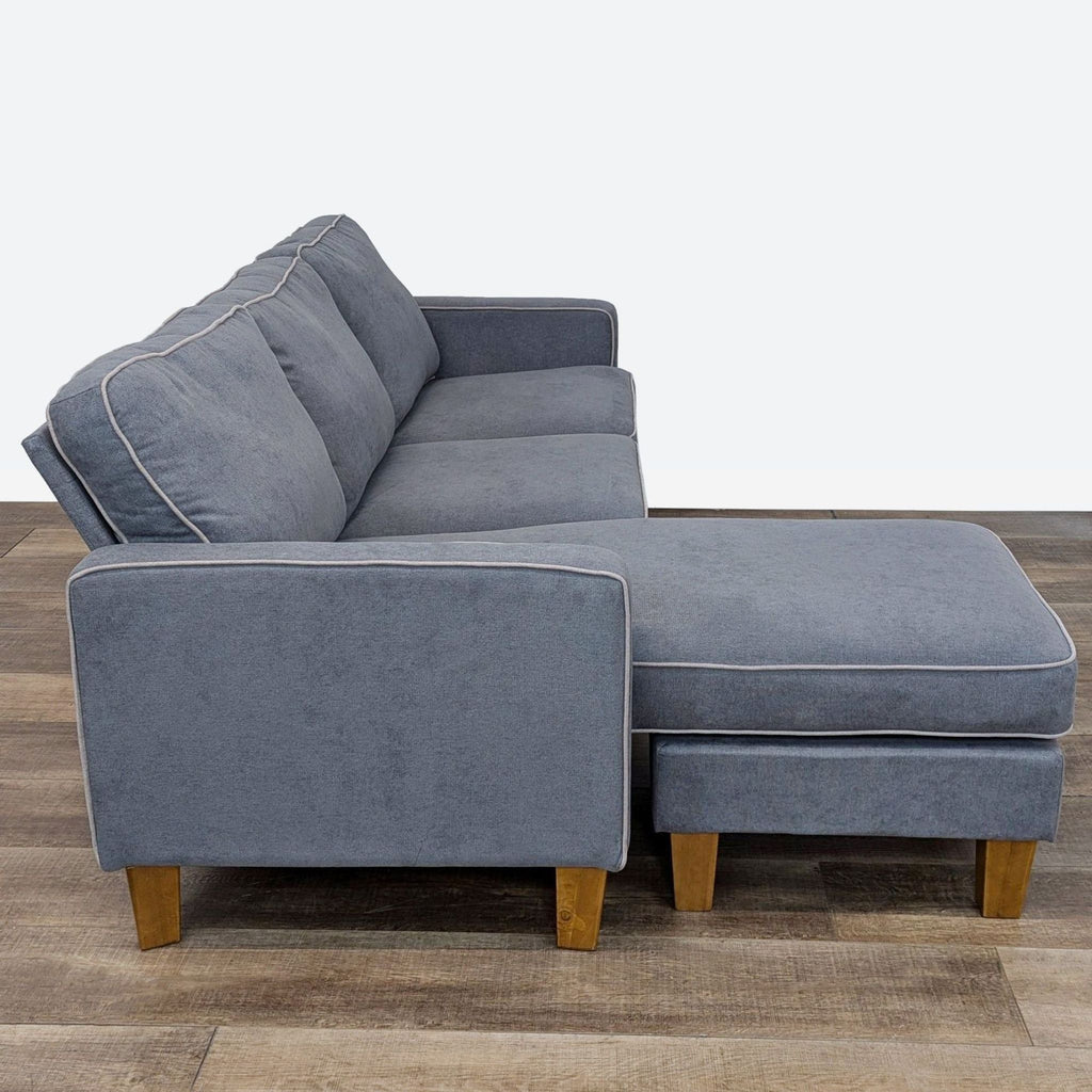 Side view of Dorel sectional sofa showcasing sleek style, chenille upholstery, and beige welt trim detail.