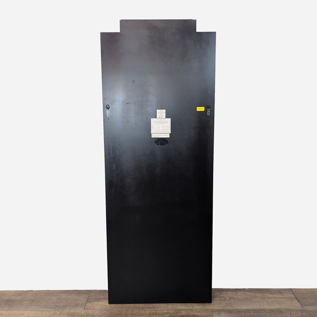 a large black metal door with a lock