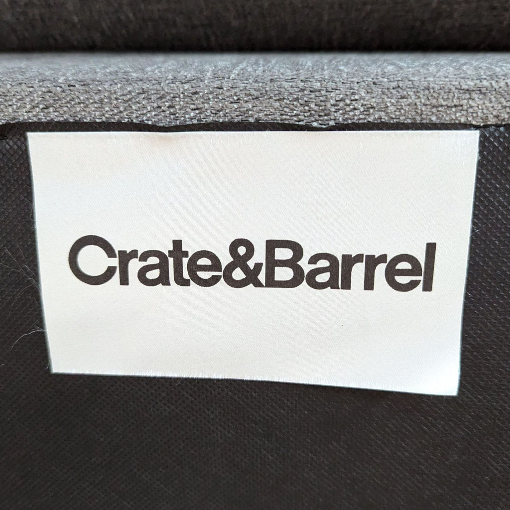 a close up of a crate & barrel label on a couch