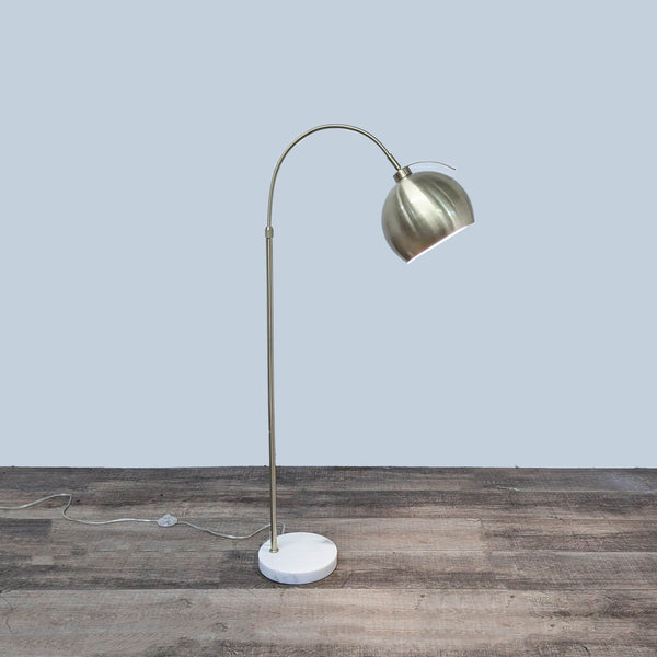 Reperch floor lamp with marble base and curved metal stem for stability and style.