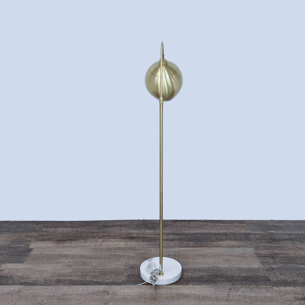 Elegant Reperch lamp featuring a sturdy marble base and arched metal design.