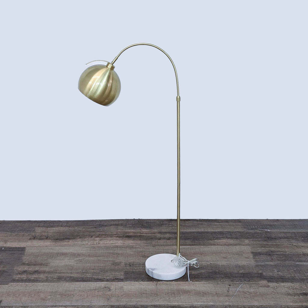Modern floor lamp by Reperch with a marble base and metallic curved stand.